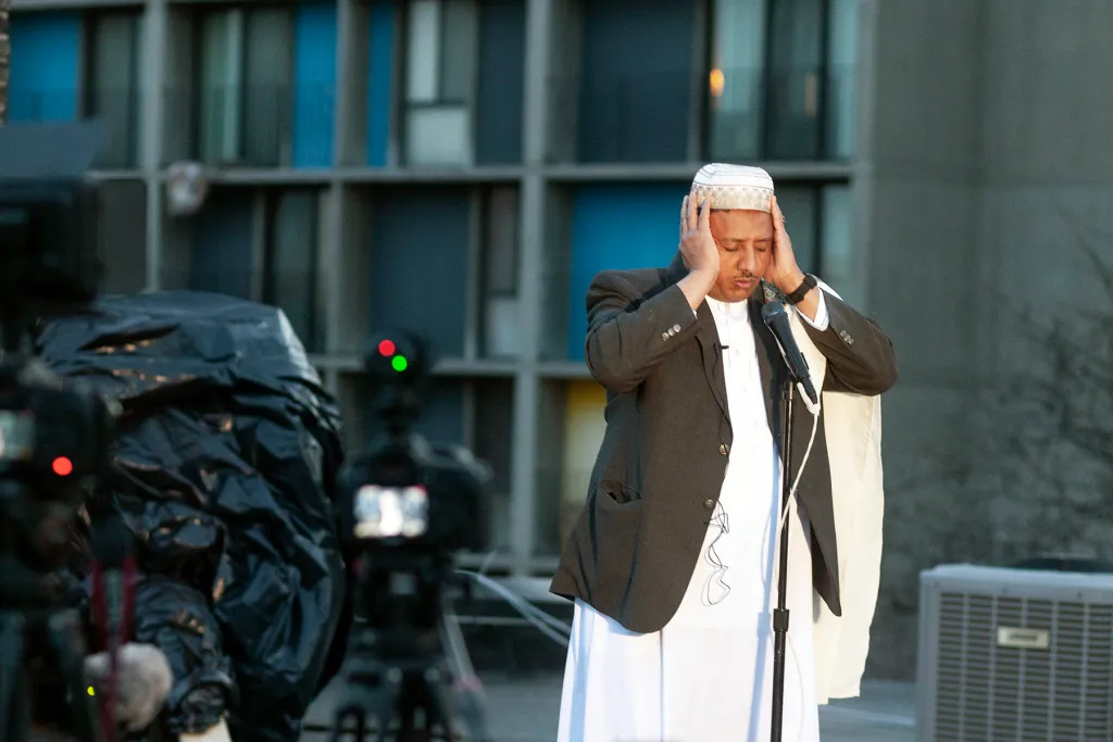 Ahmed Jamal, the mu'adhin of Dar Al-Hijrah Mosque, gives the call to prayer (adhan) from the mosque's roof in the Cedar-Riverside neighborhood on April 23, 2020. Credit: Ben Hovland | Sahan Journal